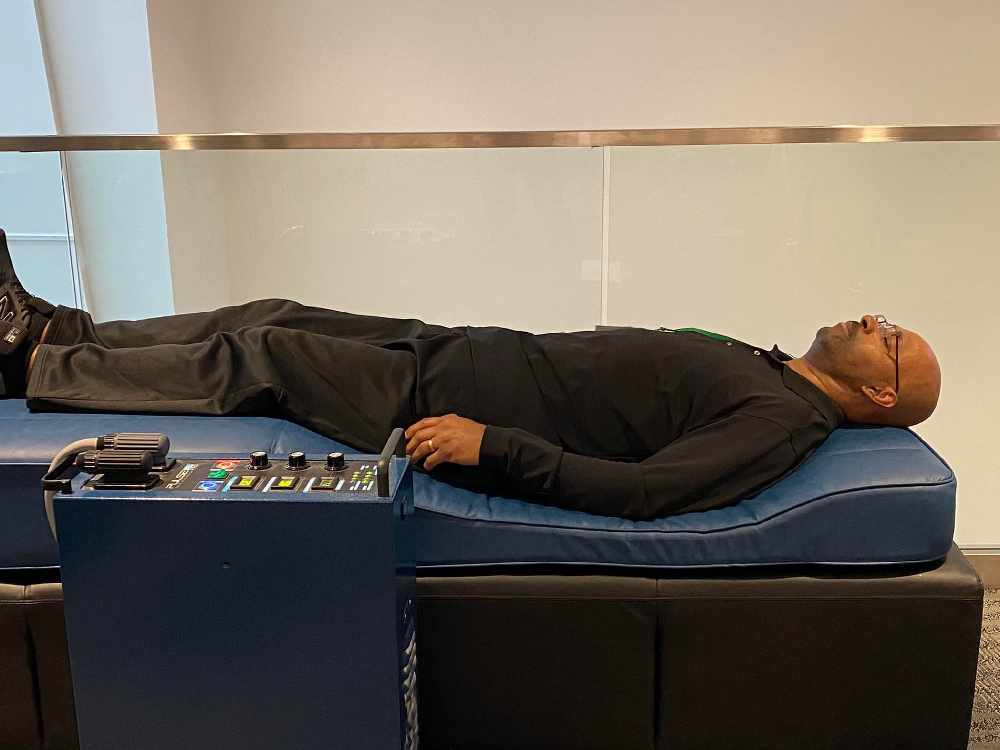 Man receiving PEMF therapy on a treatment bed